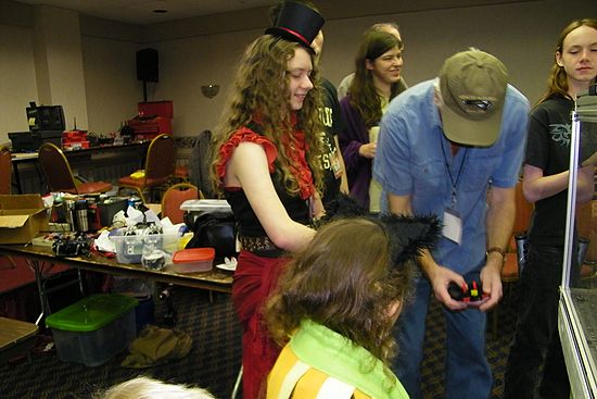 ORC offical Ron Barron showing "steam punk girl" how to drive house robot